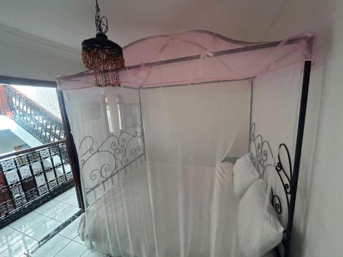 a bed with a canopy in a room at Riad Four Rooms & Pool in Marrakesh