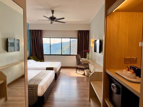 a hotel room with two beds and a window at Copthorne Hotel Cameron Highlands in Cameron Highlands