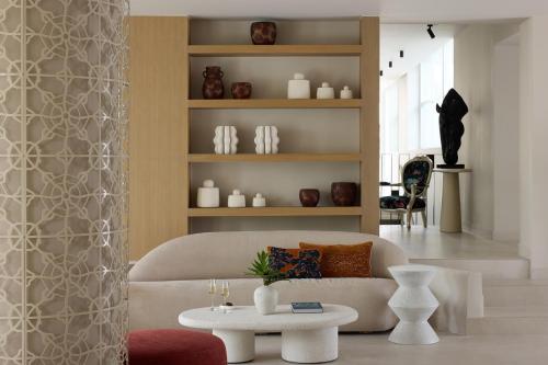 a living room with a couch and a table at Santorini Heart Hotel & Spa in Fira