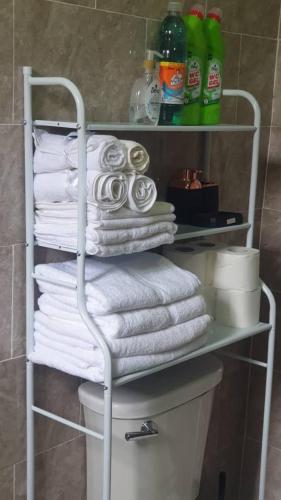 a towel rack with a bunch of towels in a bathroom at Grace View Villa in Trofwi