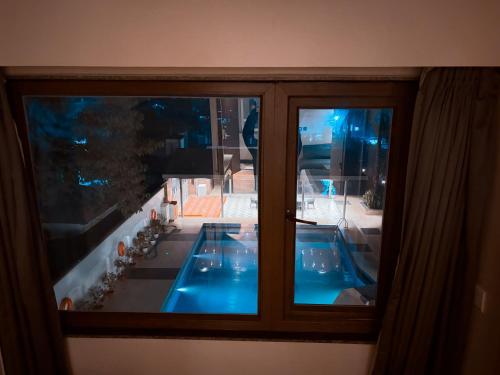 a view of a swimming pool through a window at The Cindrella Hotel in Siliguri