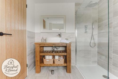 a bathroom with a sink and a shower at Luxury 2-Bed House in Stevenage Sleeps 6 Free Parking Barefoot & Board in Shephall