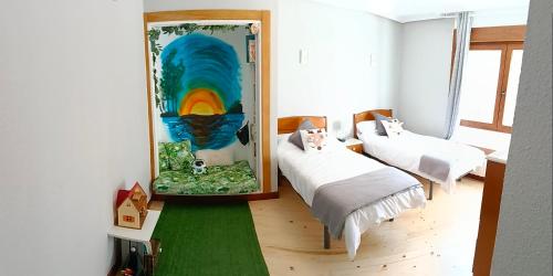 a room with two beds and a mirror at El sol y la mar in Colindres