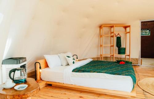 a bedroom with a bed and a table at Rafiki Retreat in Arusha