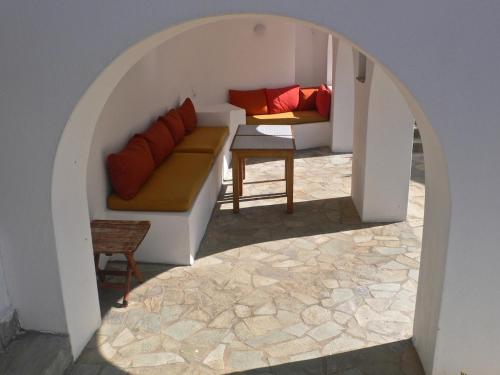 a living room with a couch and a table at Villa G - Kamari Village in Kastraki