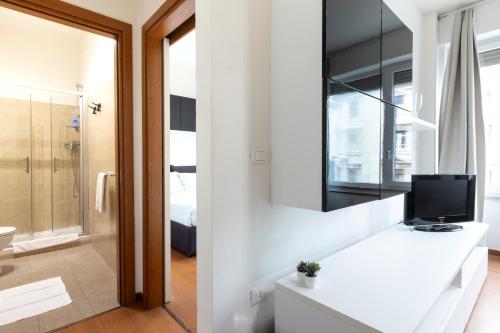 a bathroom with a white counter with a television on it at Pescara Centro sul Mare in Pescara