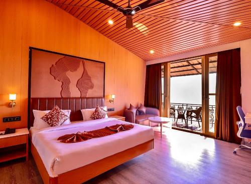 a bedroom with a large bed and a balcony at Blue Pine Resort in Lansdowne