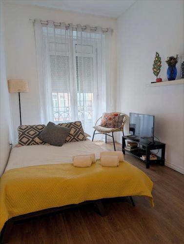 a bedroom with a large bed with a yellow blanket at Beautiful Infante Apartment in Porto