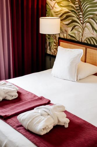a hotel room with two towels on a bed at Hôtel Paris Neuilly in Neuilly-sur-Seine
