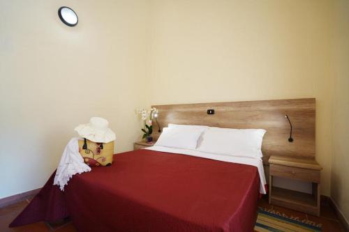 a bedroom with a bed with a red bedspread at Torre Sant'Irene Club in Sant'Irene-Briatico