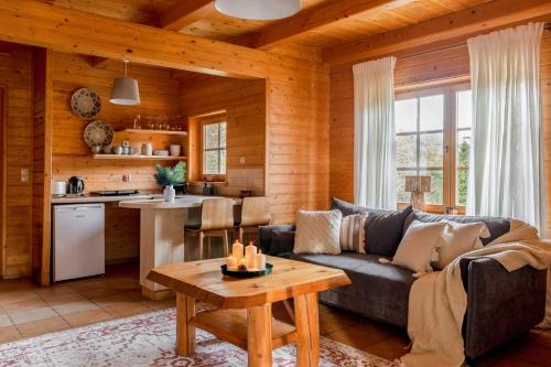a living room with a couch and a table at Domki Bystre in Baligród