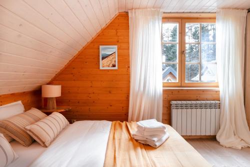 a bedroom with a bed in a wooden house at Domki Bystre in Baligród