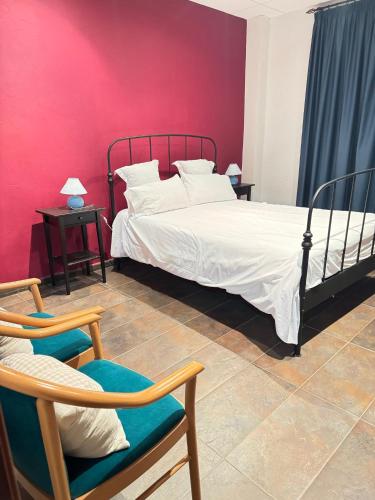a bedroom with a bed and a red wall at Hotel Restaurante Sonsoles in Ávila