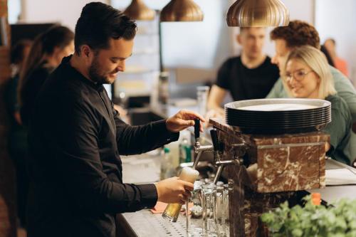 a man sitting at a bar with a machine at The Resting Place in Lemgo