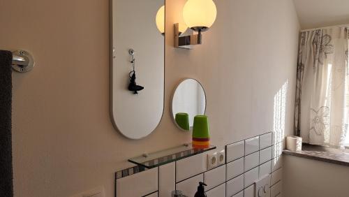 a bathroom with a mirror and a sink at Ferienwohnung Auguste in Munster
