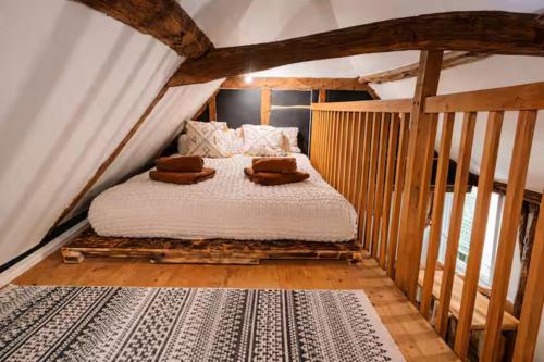 a bedroom with a bed in an attic at Cadnam Cottage with Private Hot Tub, New Forest in Cadnam