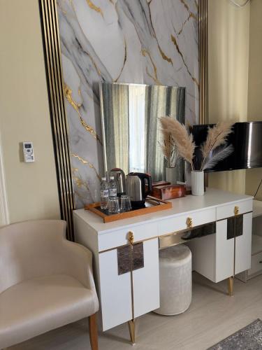 a dressing table with a mirror and a chair at Aktau Airport Hotel in Aktau