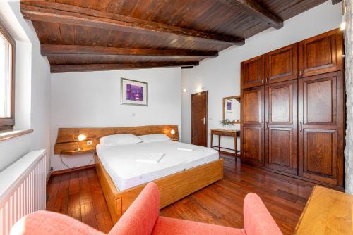 a bedroom with a bed and two chairs in it at Brela Seaview Apartment with Swimming Pool & Parking in Brela