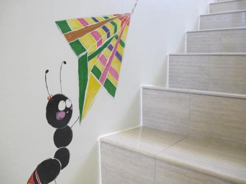 a kite hanging on a wall next to some stairs at ChaoPingJia Fengge Guesthouse in Wujie