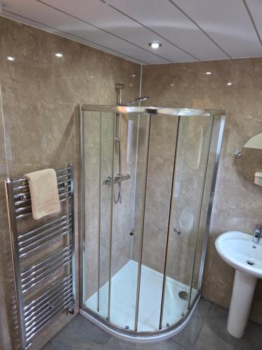 a bathroom with a shower and a sink at Ardgay in Fort Augustus