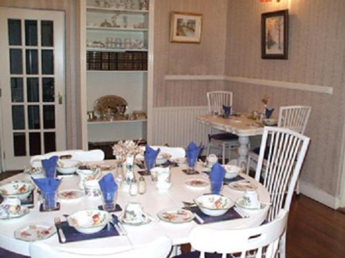 a white table with chairs and plates on it at Chaplins Townhouse in Kilkenny