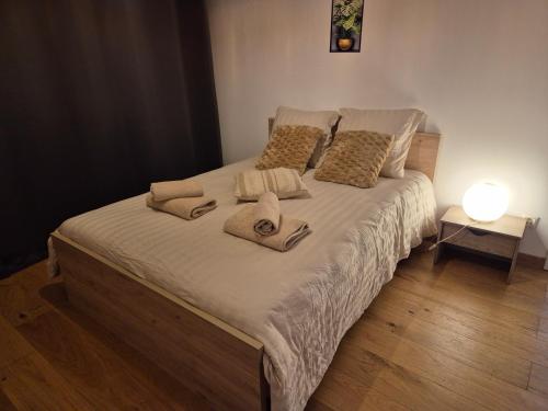a bed with towels and pillows on it in a bedroom at Le lumineux-T2 calme-animaux acceptés-place auto in Saint-Gaudens