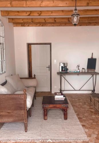 a living room with a couch and a coffee table at LE petit CHABO in Saint-Maigrin