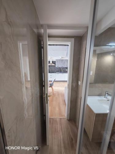 a view of a bathroom with a sink and a mirror at La Dimora di Tuya Superior in Naples