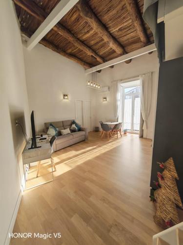 a living room with a couch and a table at La Dimora di Tuya Superior in Naples