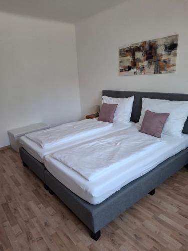 a large bed in a room with white walls at Ferienwohnung Wagner in Stegersbach