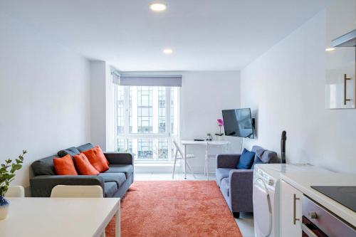 a living room with a couch and a table at Modern 3-Bedroom Apartment in Leeds City Centre - Sleeps 6 in Elland