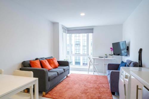 a living room with a couch and a table at Modern 3-Bedroom Apartment in Leeds City Centre - Sleeps 6 in Elland