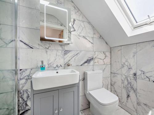 a bathroom with a sink and a toilet at 4 Bed in Talsarnau oc-96164 in Talsarnau