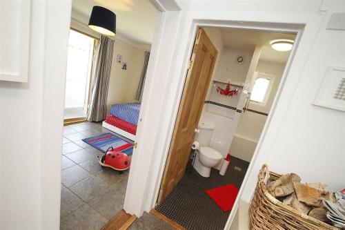 a small room with a bedroom with a bed and a toilet at 2 Bed in Gower oc-hh411 in Parkmill