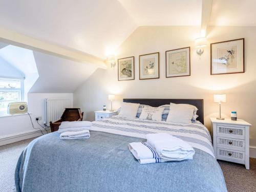 a bedroom with a large bed with towels on it at 1 Bed in Presteigne oc-53667 in Presteigne