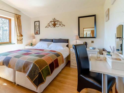 a bedroom with a bed and a desk and a mirror at 1 Bed in Lampeter oc-43288 in Tregaron