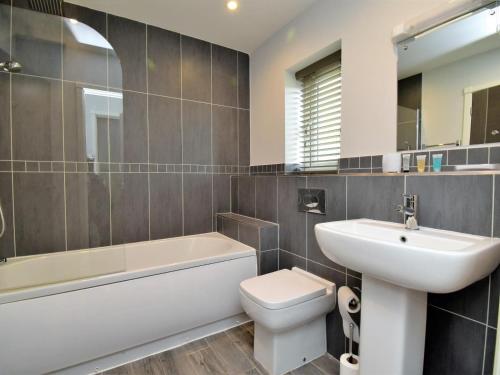 a bathroom with a sink and a toilet and a bath tub at 4 Bed in Oswestry oc-74110 in Kinnerley
