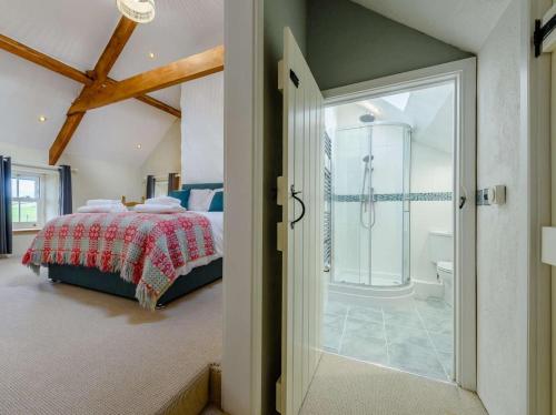 a bedroom with a bed and a walk in shower at 4 Bed in Llandysul oc-89422 in Cwm-pengraig