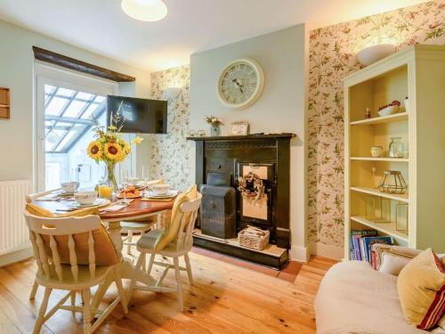 a dining room with a table and a fireplace at 2 Bed in Milford Haven oc-88529 in Milford Haven