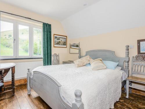 a bedroom with a large bed and a window at 4 Bed in Llandinam oc-51651 in Llandinam