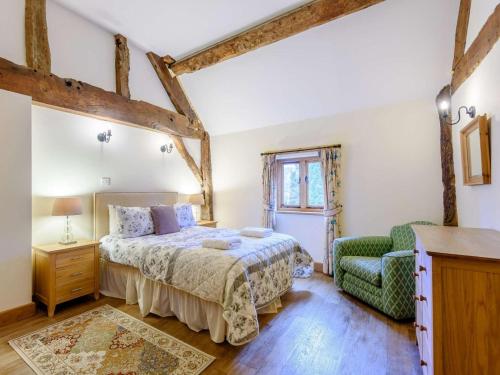 a bedroom with a bed and a chair at 4 Bed in Newtown oc-86784 in Bettws Cedewain