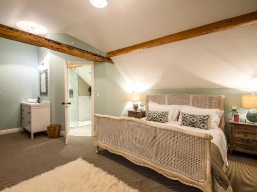 a bedroom with a large bed and a bathroom at 5 Bed in Whitchurch oc-77696 in Whitchurch
