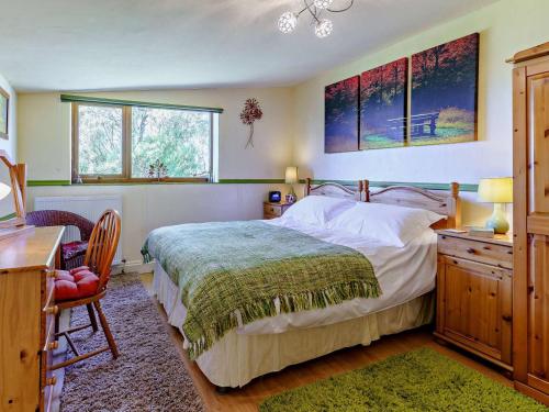 a bedroom with a bed and a desk and a desk at 2 Bed in Lampeter oc-43293 in Tregaron