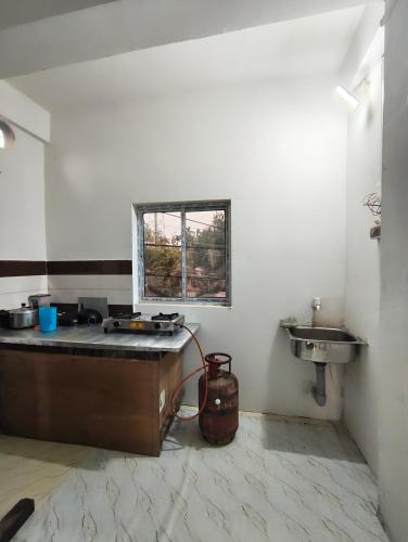 a kitchen with a sink and a counter in a room at Green leaf homes in North Lakhimpur