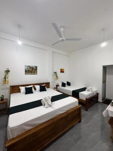 two beds in a room with two beds sidx sidx sidx sidx at Tuskers edge Retreat in Udawalawe