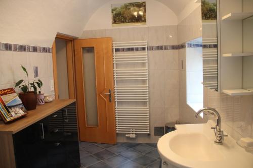 a bathroom with a sink and a toilet and a mirror at Ferienwohnung Vorstadt in Gmünd in Kärnten