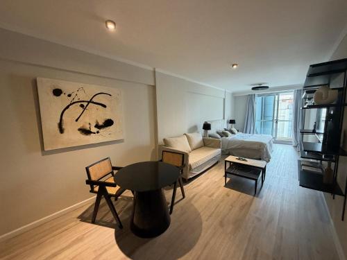 a living room with a couch and a table at Deco Recoleta in Buenos Aires