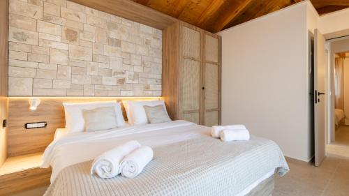 a bedroom with a white bed with towels on it at Villa Silvana by Villas Guide in Blato