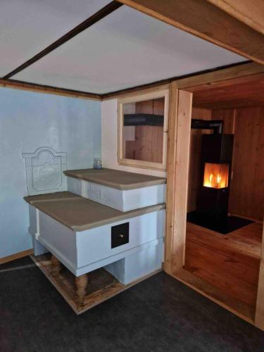 a small kitchen with a stove in a room at Swiss Mountain Chalet in Saxeten