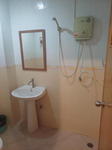 a bathroom with a sink and a mirror and a shower at Skippers inn pier 55 Bar&Guesthouse in Hua Hin